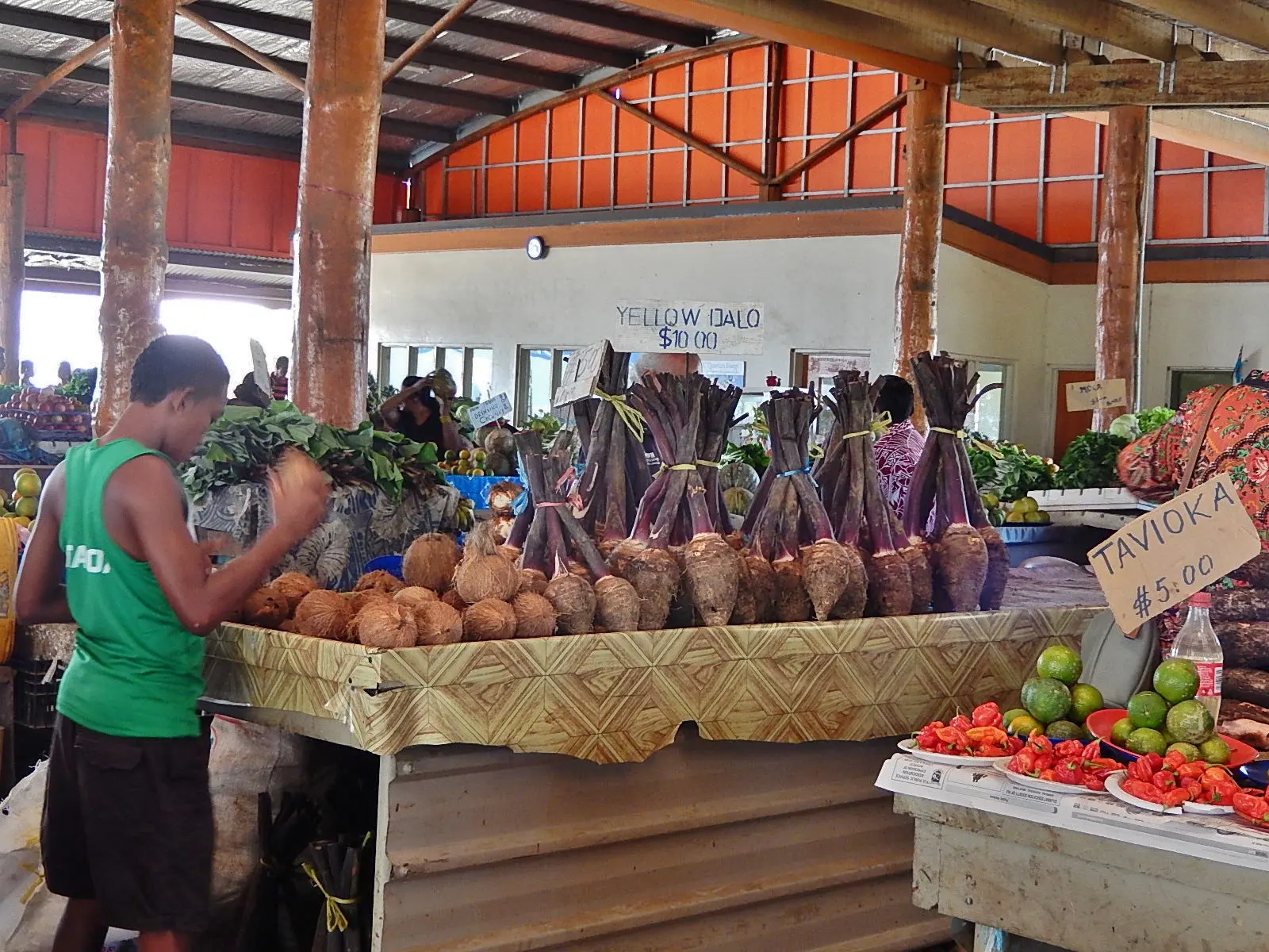 Dalo (taro) and coconuts for sale at a local market in Fiji